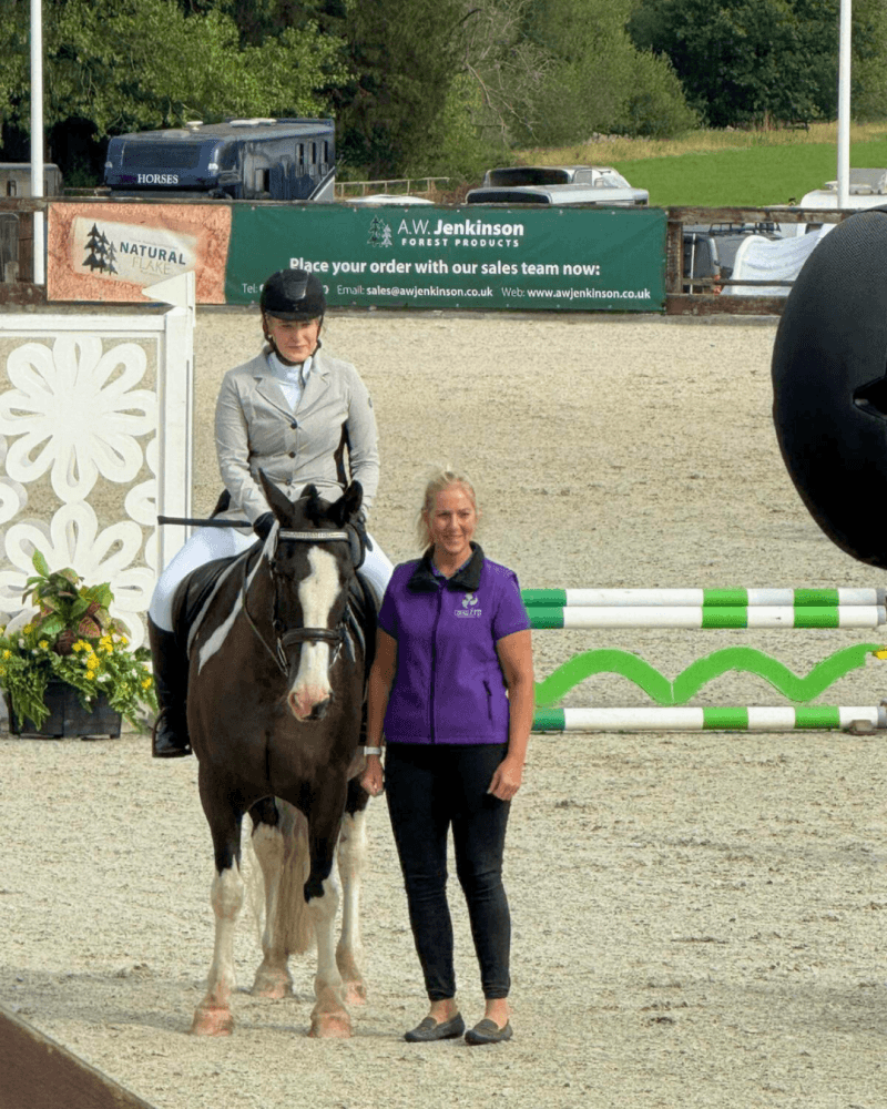 Cavaletti Collection team member standing beside a rider on a piebald cob at the SEIB Trailblazers Championships