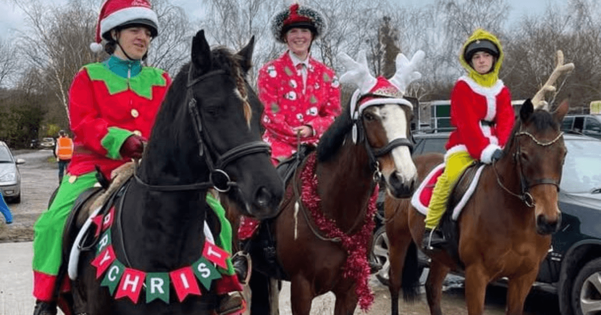Three riders and ponies in Christmas fancy dress, including elf, reindeer and Santa costumes